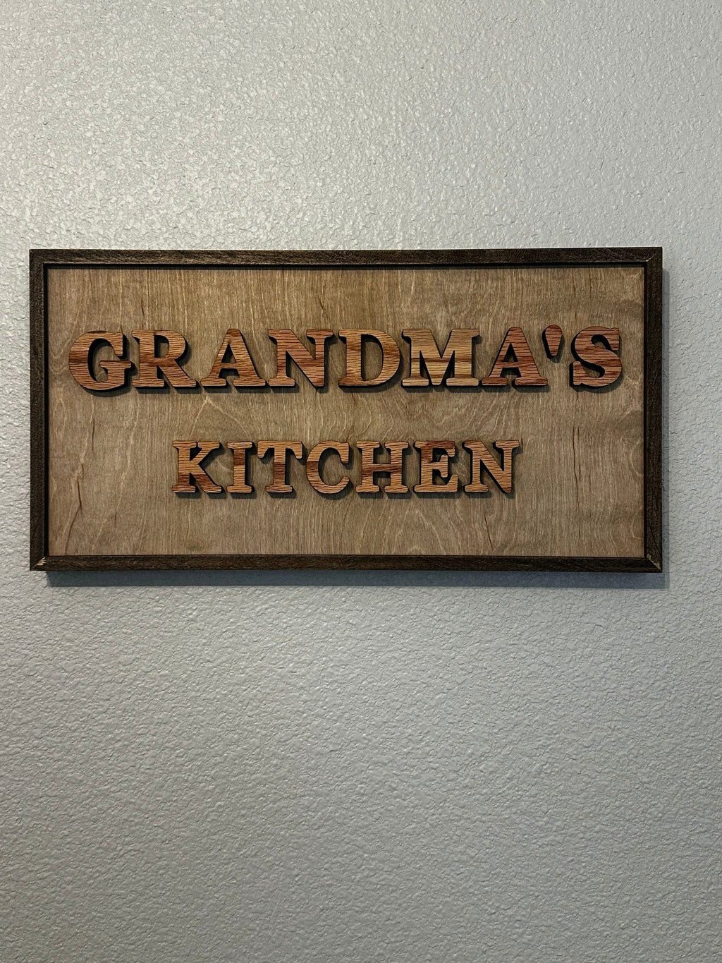 Grandma’s Kitchen framed wood sign with raised lettering and dark wood frame for kitchen wall decor