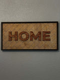 HOME framed wood sign with layered raised letters and laser-engraved geometric background in a dark wood frame.