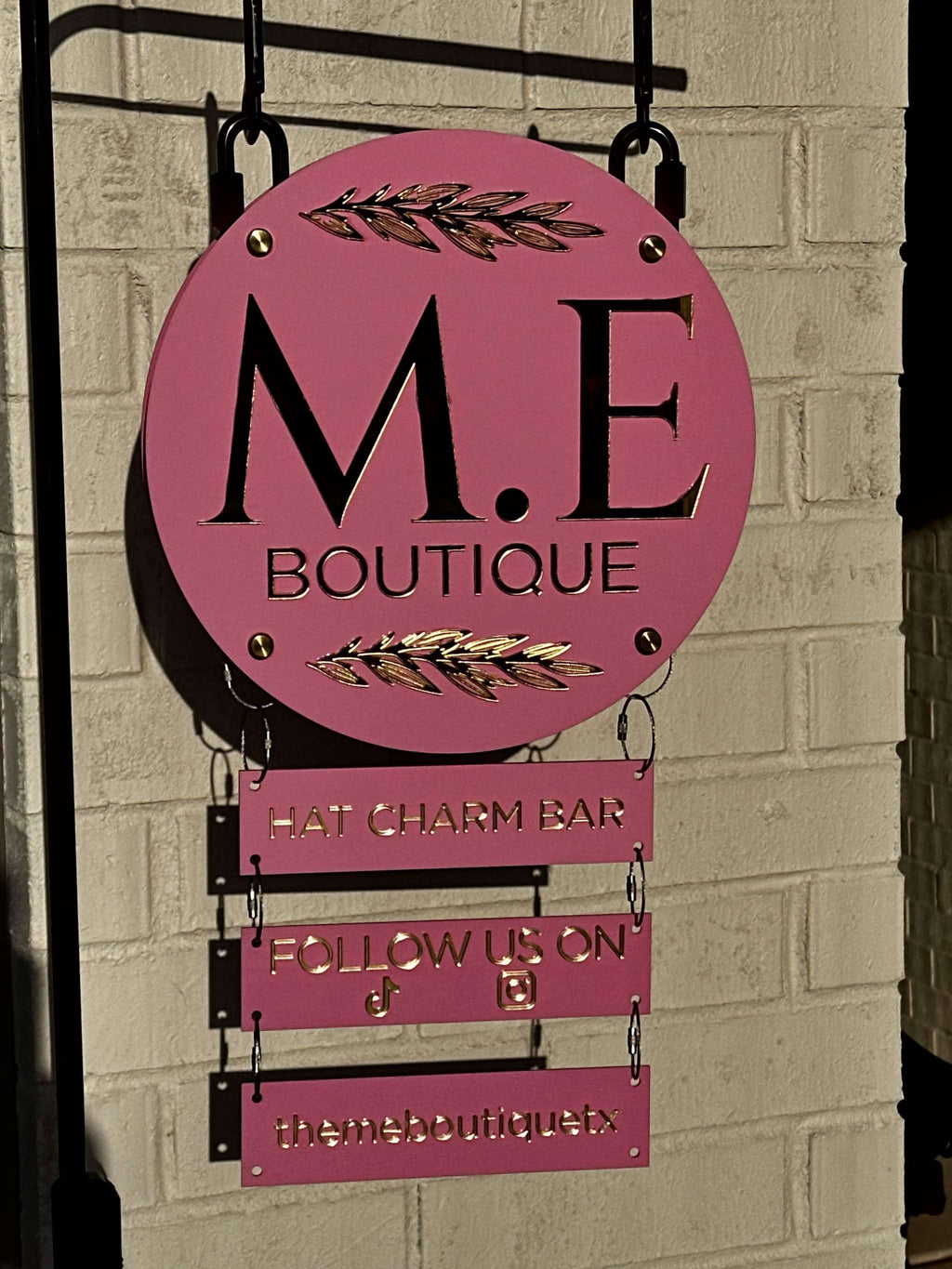 Custom vendor booth sign system with modular hanging acrylic panels and branding elements