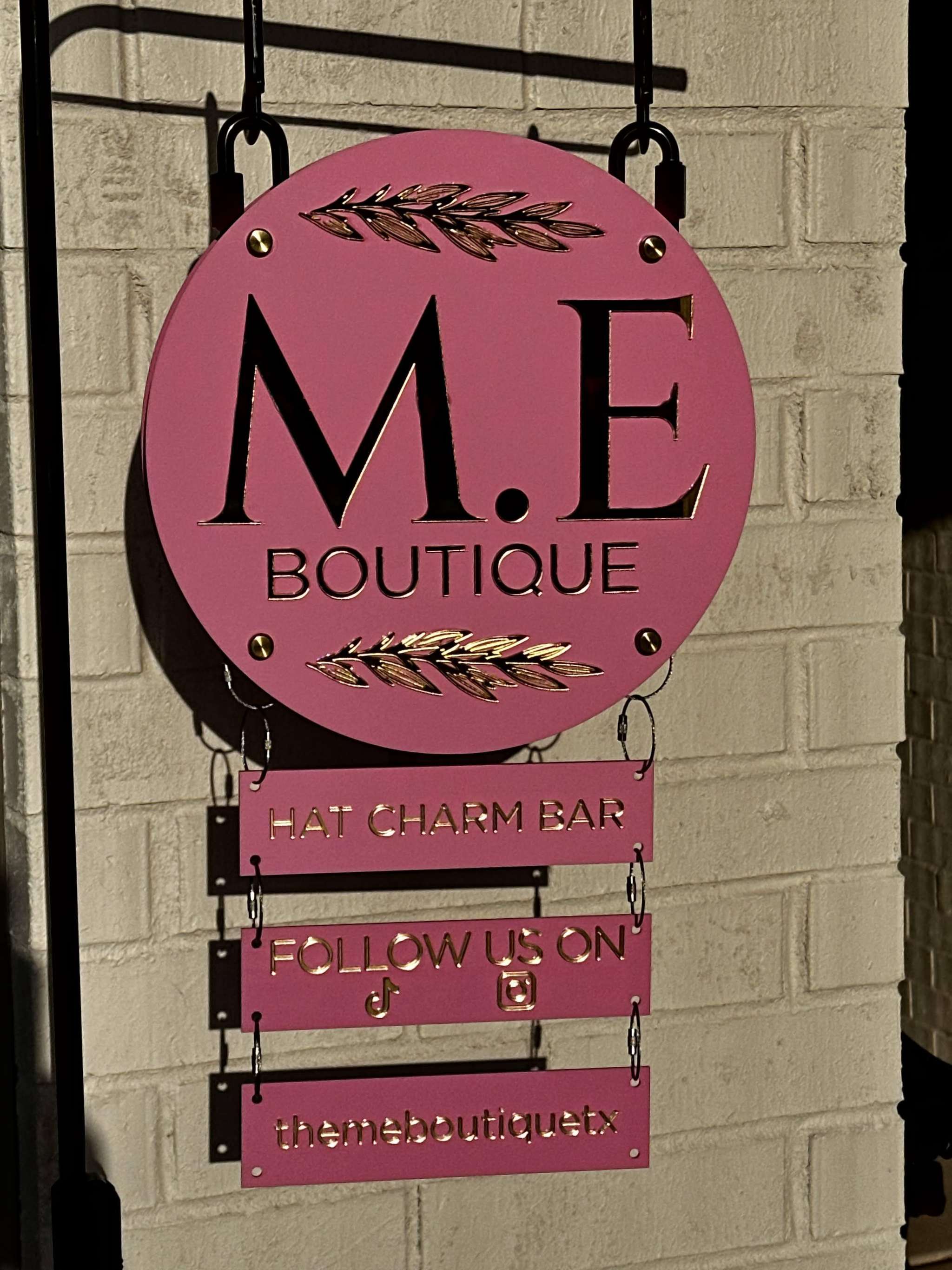 Custom vendor booth sign system with modular hanging acrylic panels and branding elements
