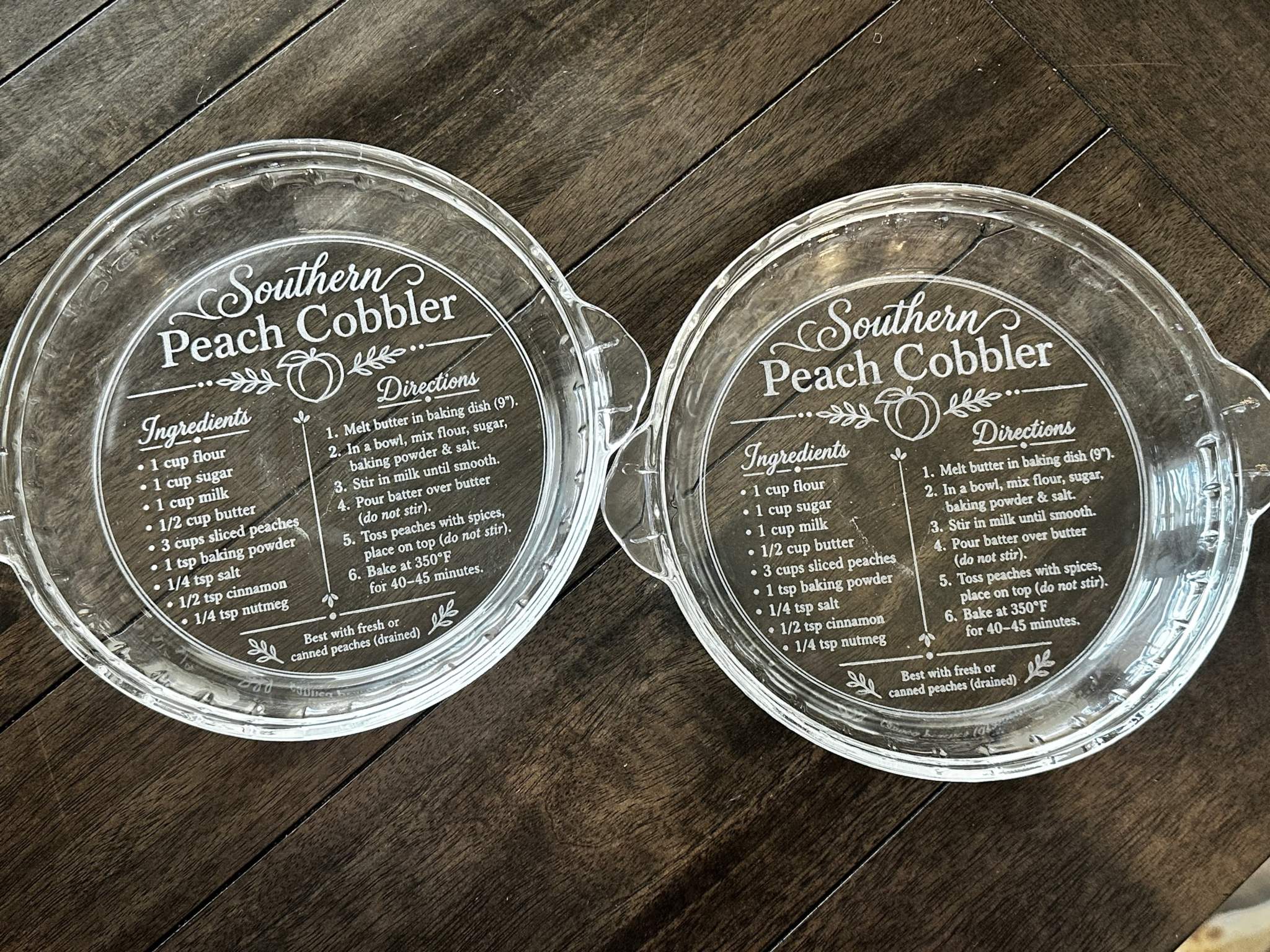 Clear glass baking dish with engraved Southern Peach Cobbler recipe on underside
