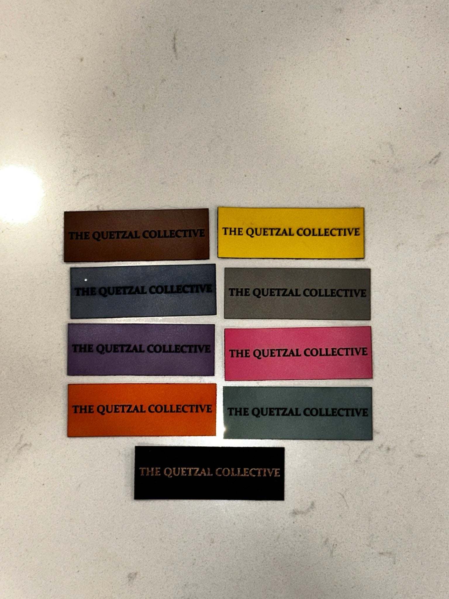 Custom leatherette business branding tags with laser-engraved logo on faux leather label