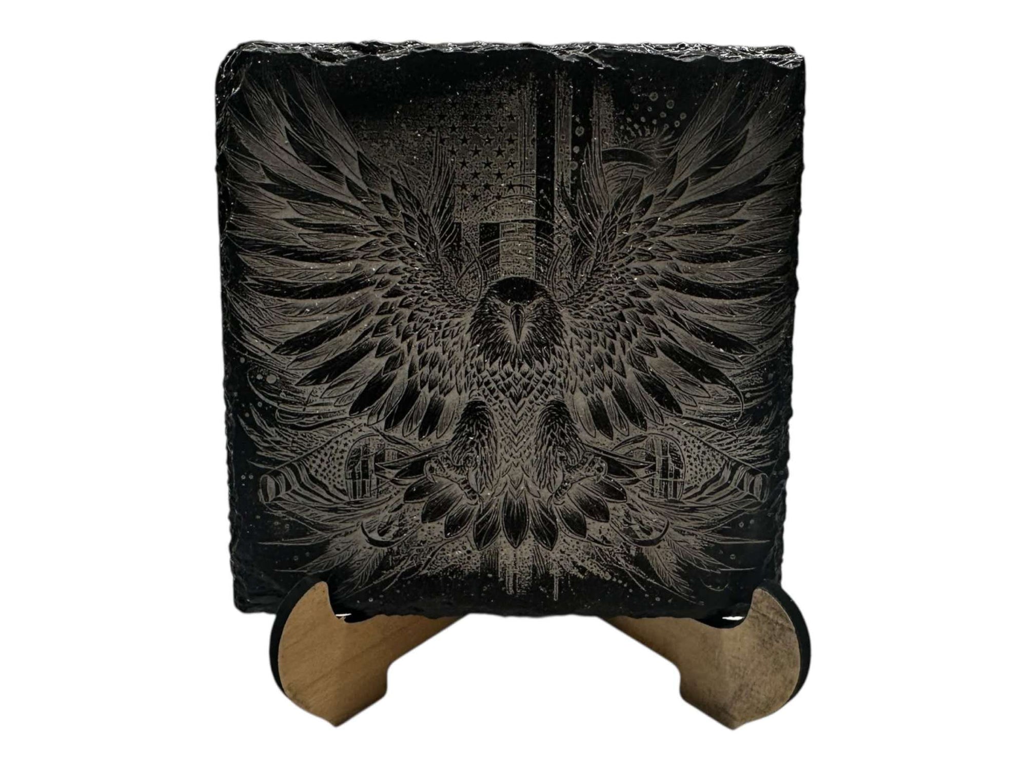 Hand-painted slate coaster with intricate black and white greyscale eagle design, displayed on a wooden stand.