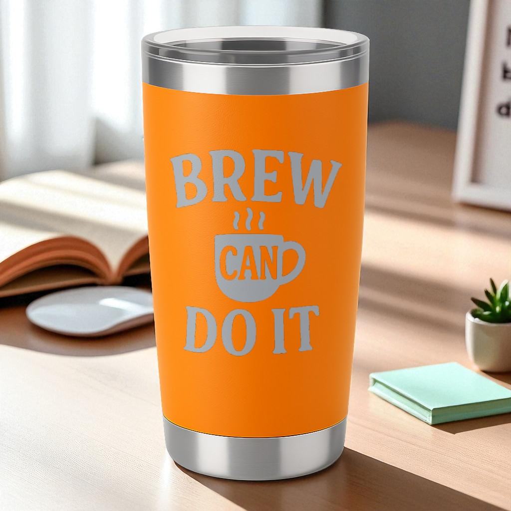 20oz orange Brew Can Do It engraved insulated stainless steel tumbler with clear lid on desk