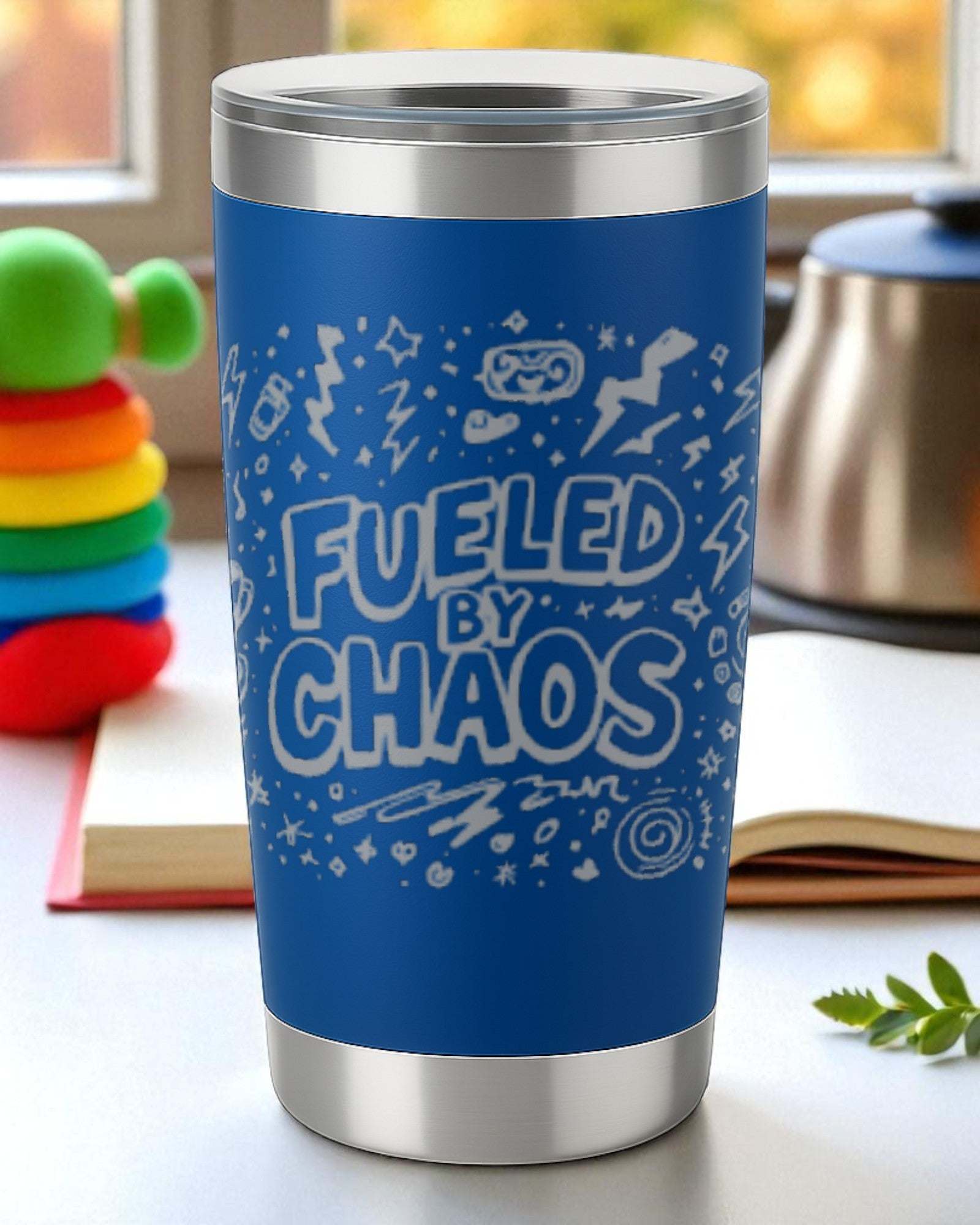 Blue stainless steel tumbler with "Fueled by Chaos" text and doodle design for chaotic life enthusiasts