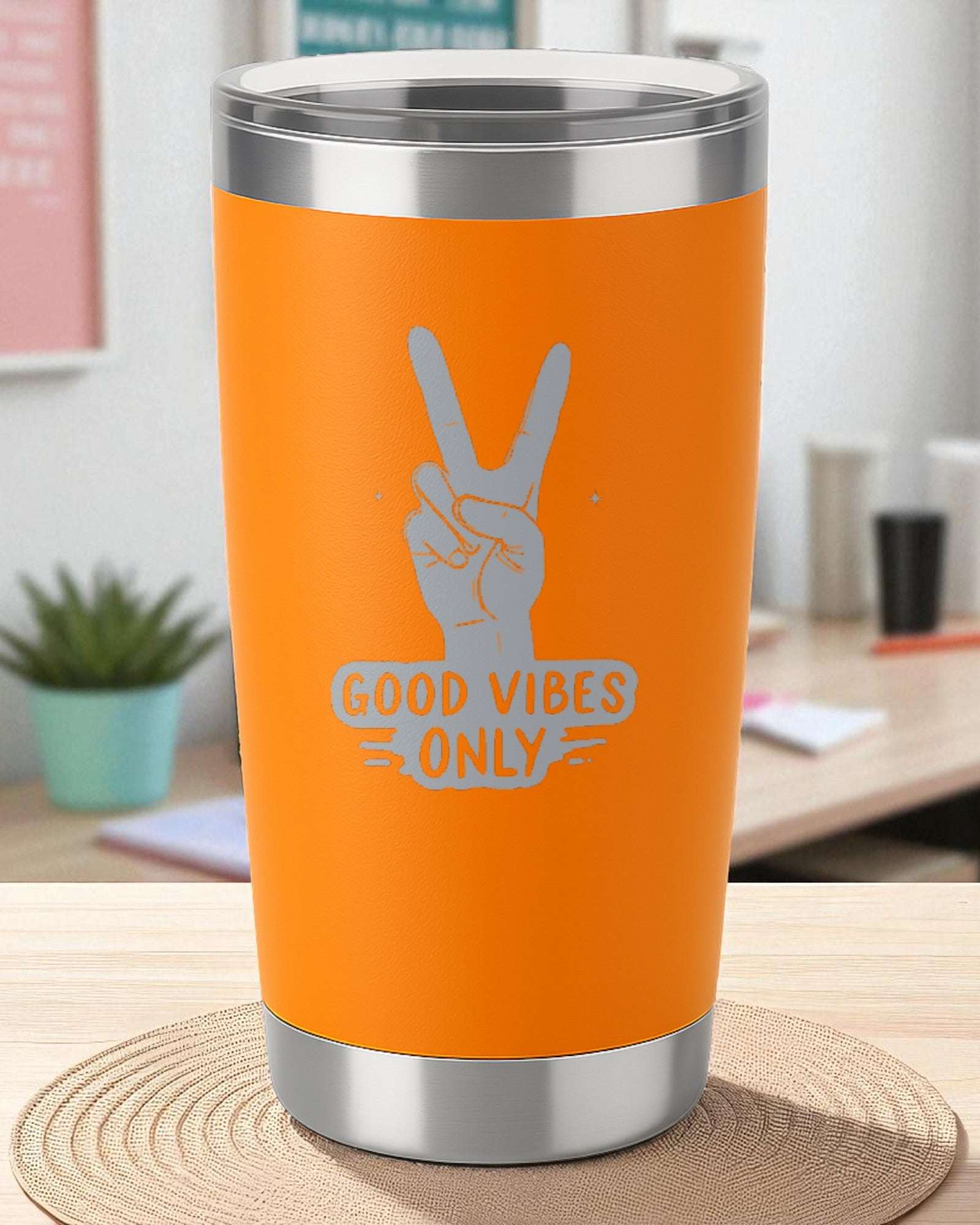 Orange Good Vibes Only tumbler with retro peace sign design on wooden table in cozy room