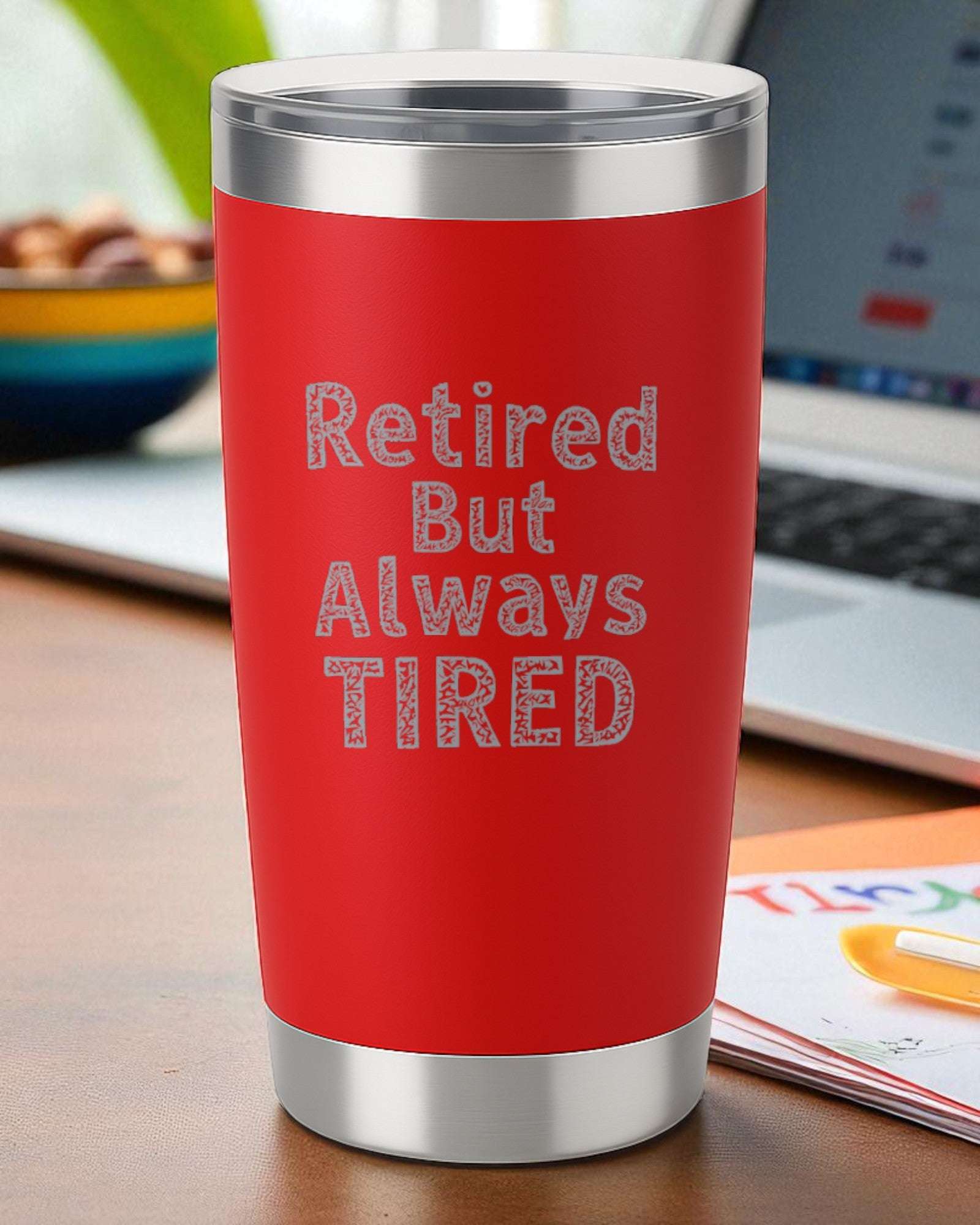 Red 20oz stainless steel tumbler with "Retired But Always Tired" engraved, double-wall insulated, clear slide lid, dishwasher safe retirement gift.