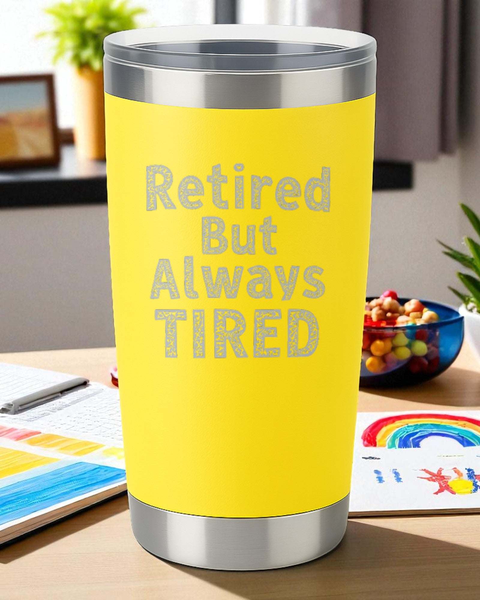 Yellow 20oz stainless steel tumbler engraved with "Retired But Always Tired" text and clear slide lid.
