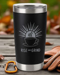 Black stainless steel coffee tumbler with "Rise and Grind" motivational design and sun graphic