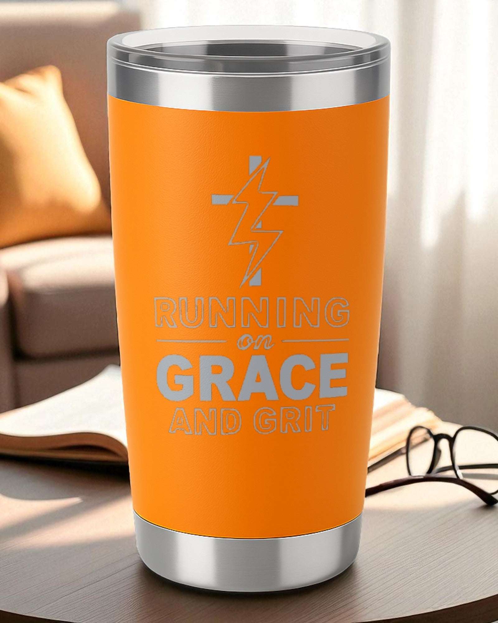 Orange 20oz engraved tumbler with "Running on Grace and Grit" design and clear lid, double-wall insulated.