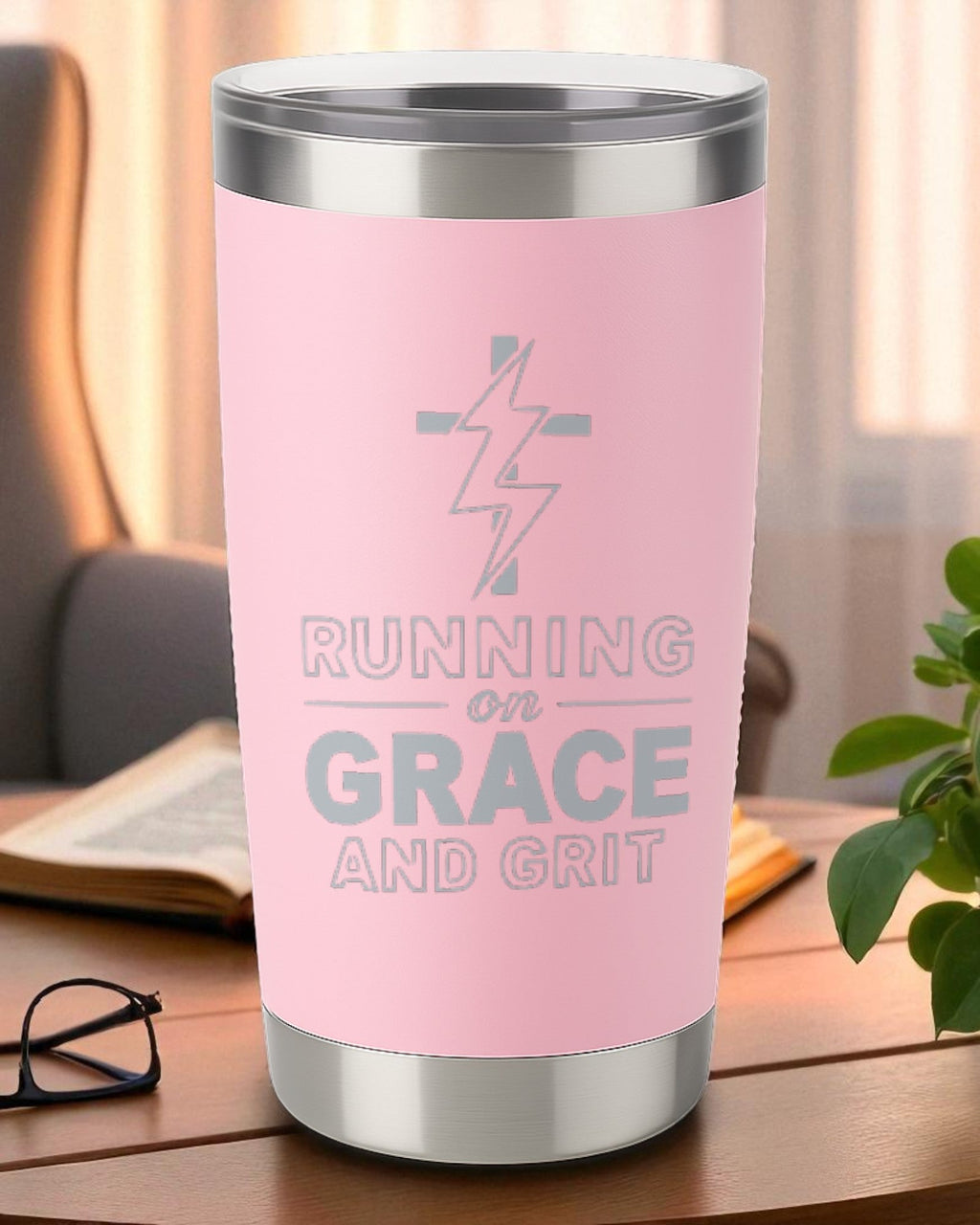 Pink 20oz engraved tumbler with "Running on Grace and Grit" text and lightning bolt design, double-wall insulated and dishwasher safe.