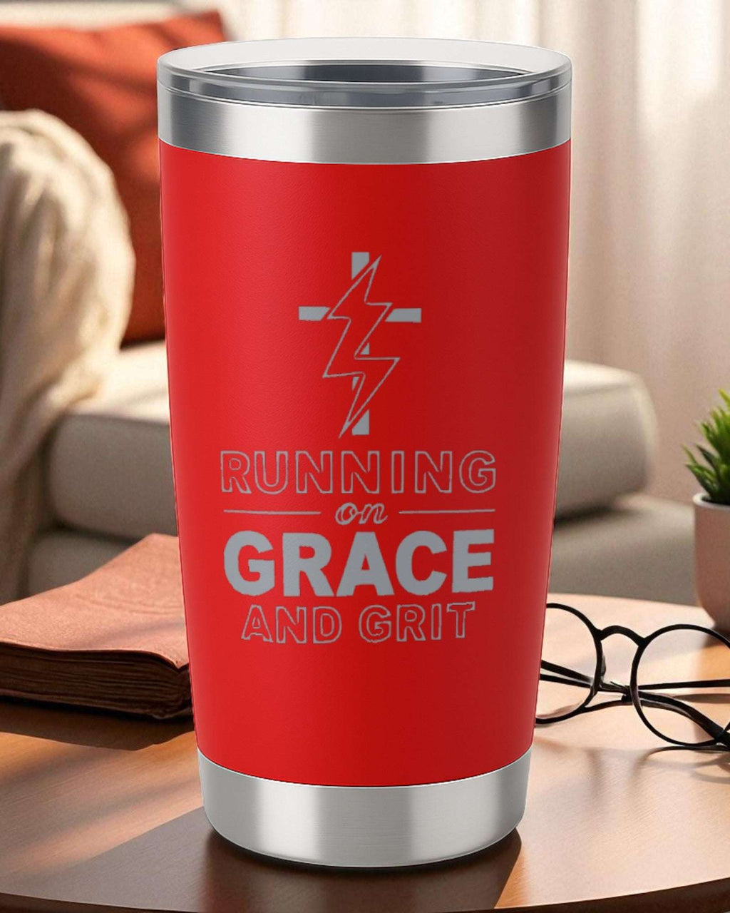 Red 20oz engraved tumbler with "Running on Grace and Grit" design and lightning bolt cross, double-wall vacuum insulated with clear lid.