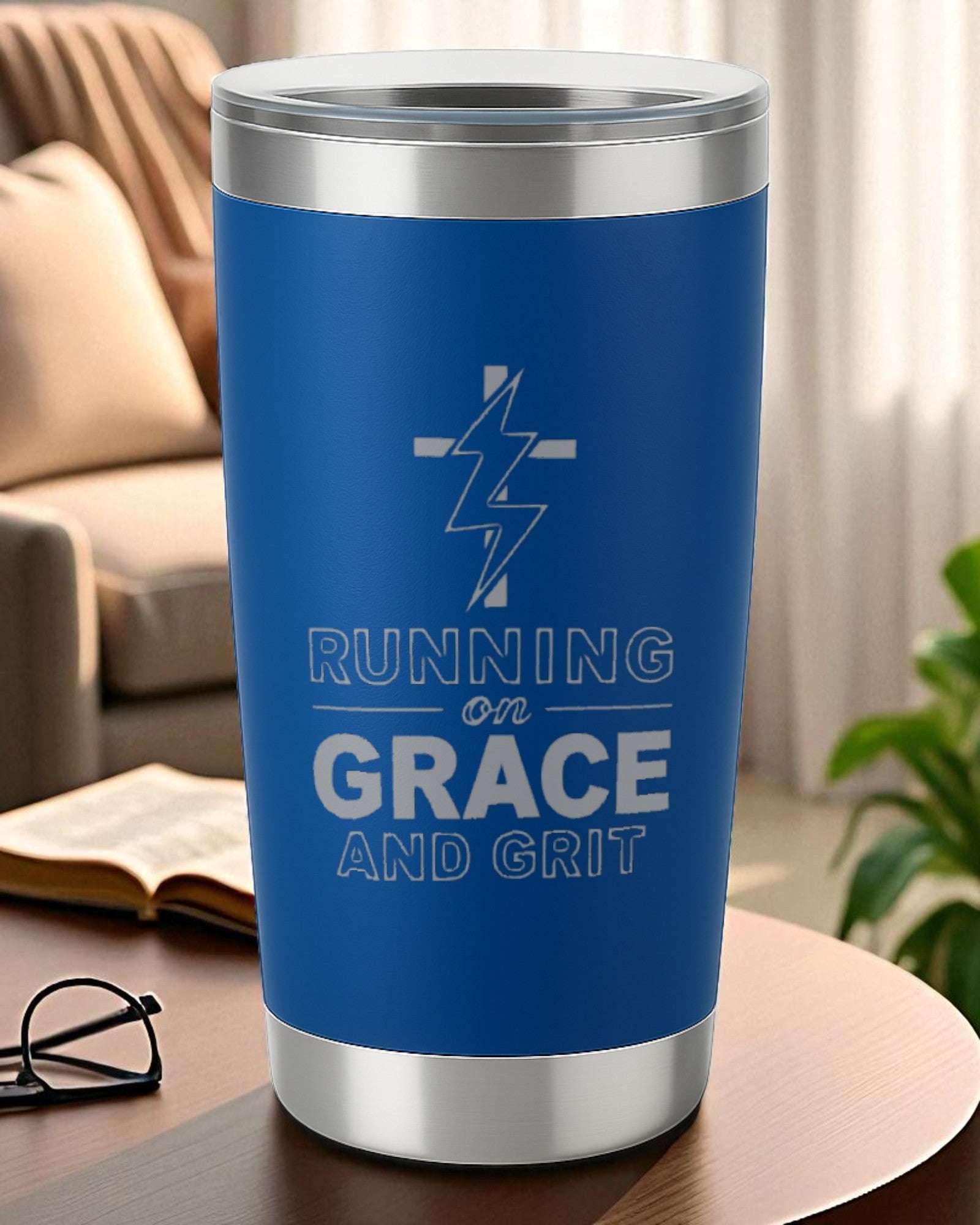 Blue 20oz engraved tumbler with "Running on Grace and Grit" motivational text and lightning bolt design.