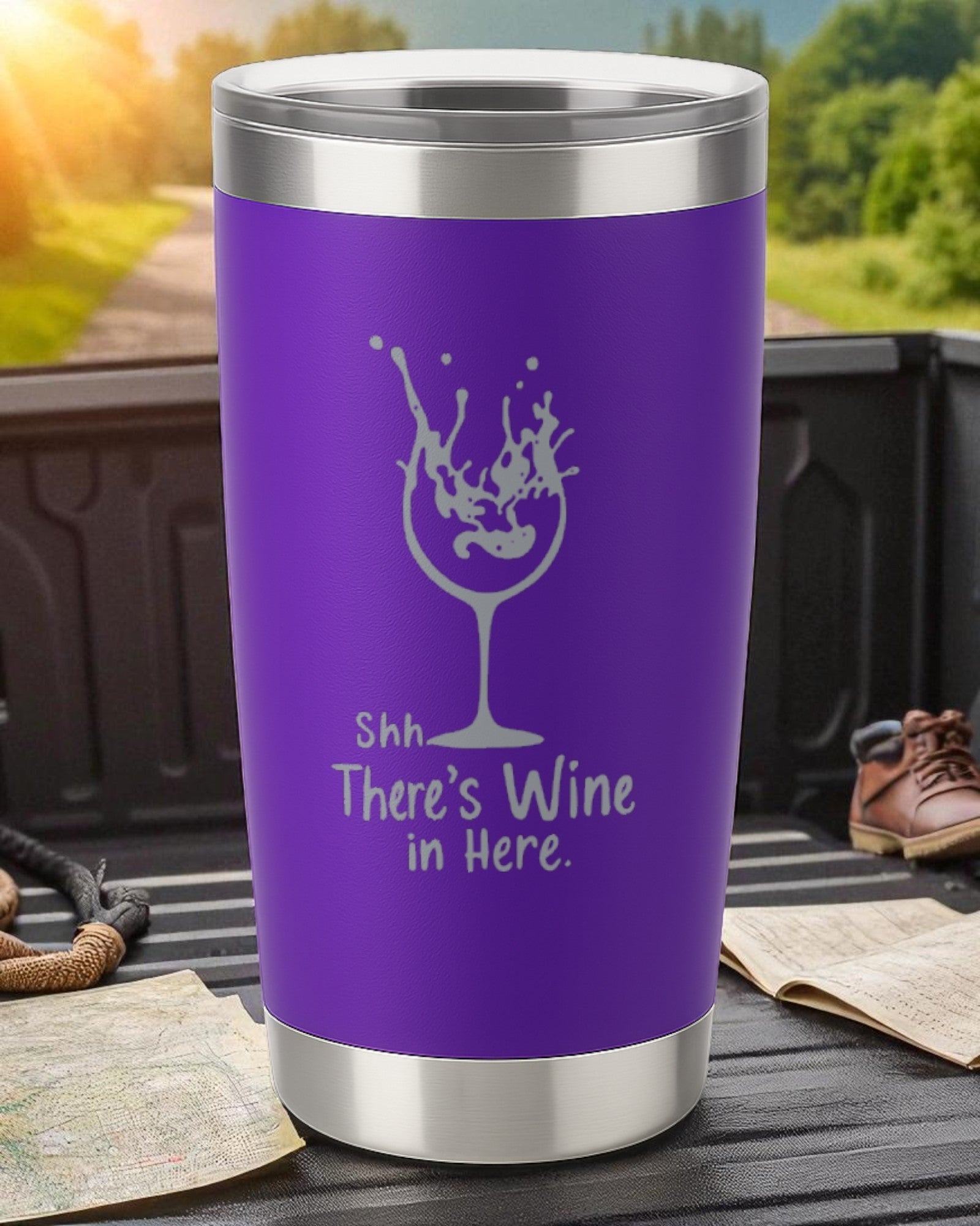 Purple 20oz stainless steel tumbler with engraved "Shhh… There’s Wine in Here" text and wine glass design, powder-coated and spill-resistant with clear lid.