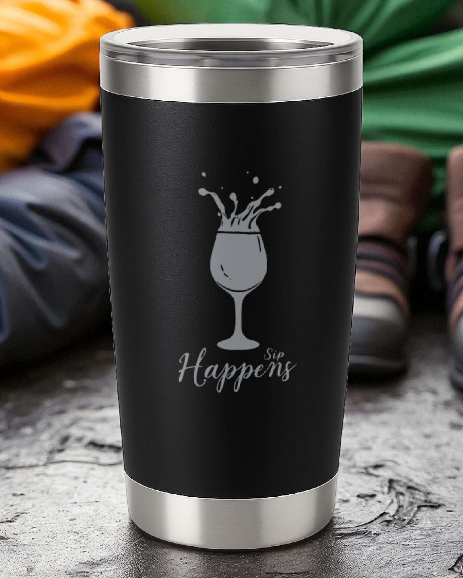 20oz black insulated tumbler with silver accents engraved with "Sip Happens" and a splashing wine glass design