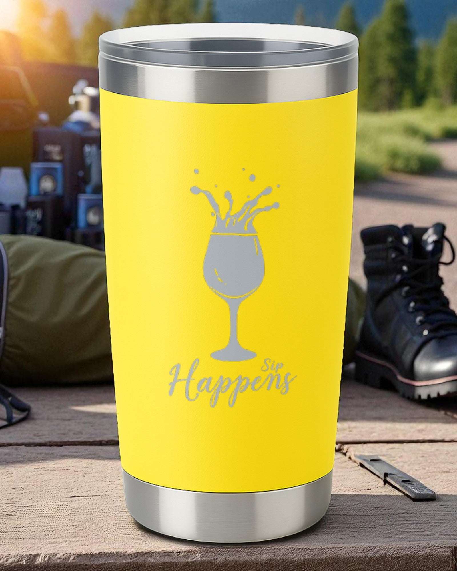 Yellow 20oz insulated tumbler with "Sip Happens" laser-engraved design and clear slide lid