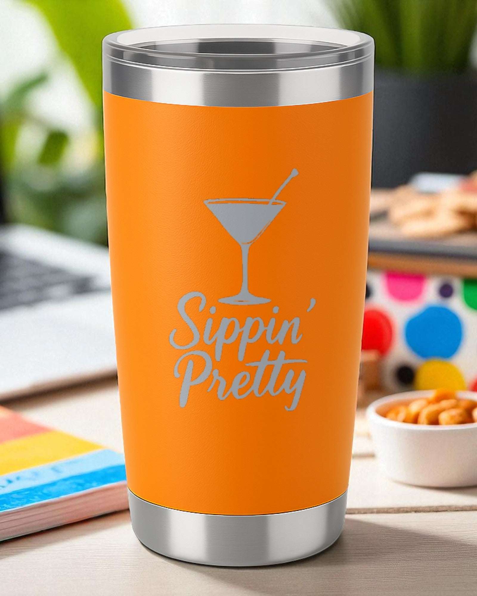Orange 20oz stainless steel tumbler engraved with "Sippin’ Pretty" and a cocktail glass design with clear lid.