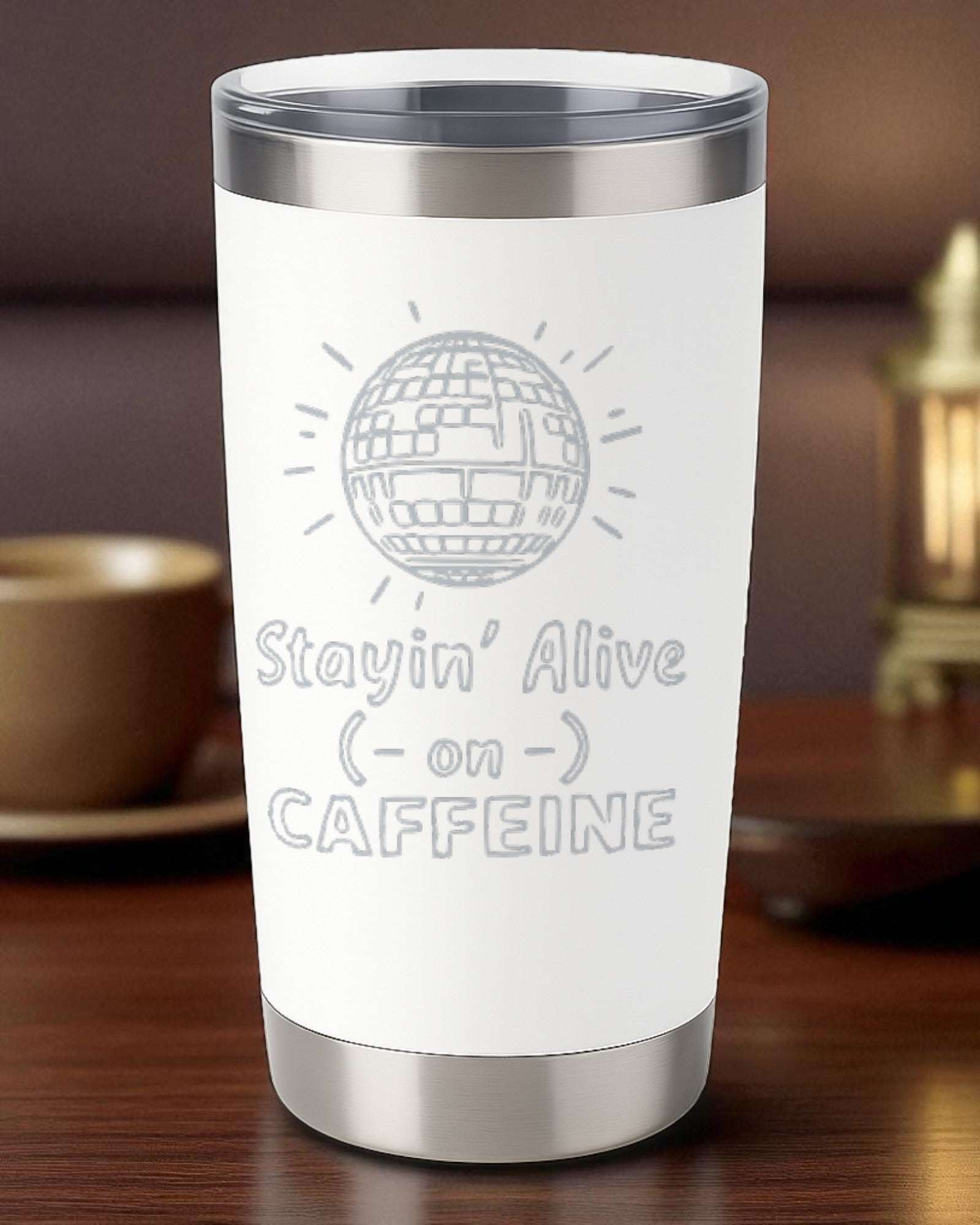 20oz stainless steel retro coffee tumbler with "Stayin' Alive on Caffeine" laser-engraved design and clear lid.