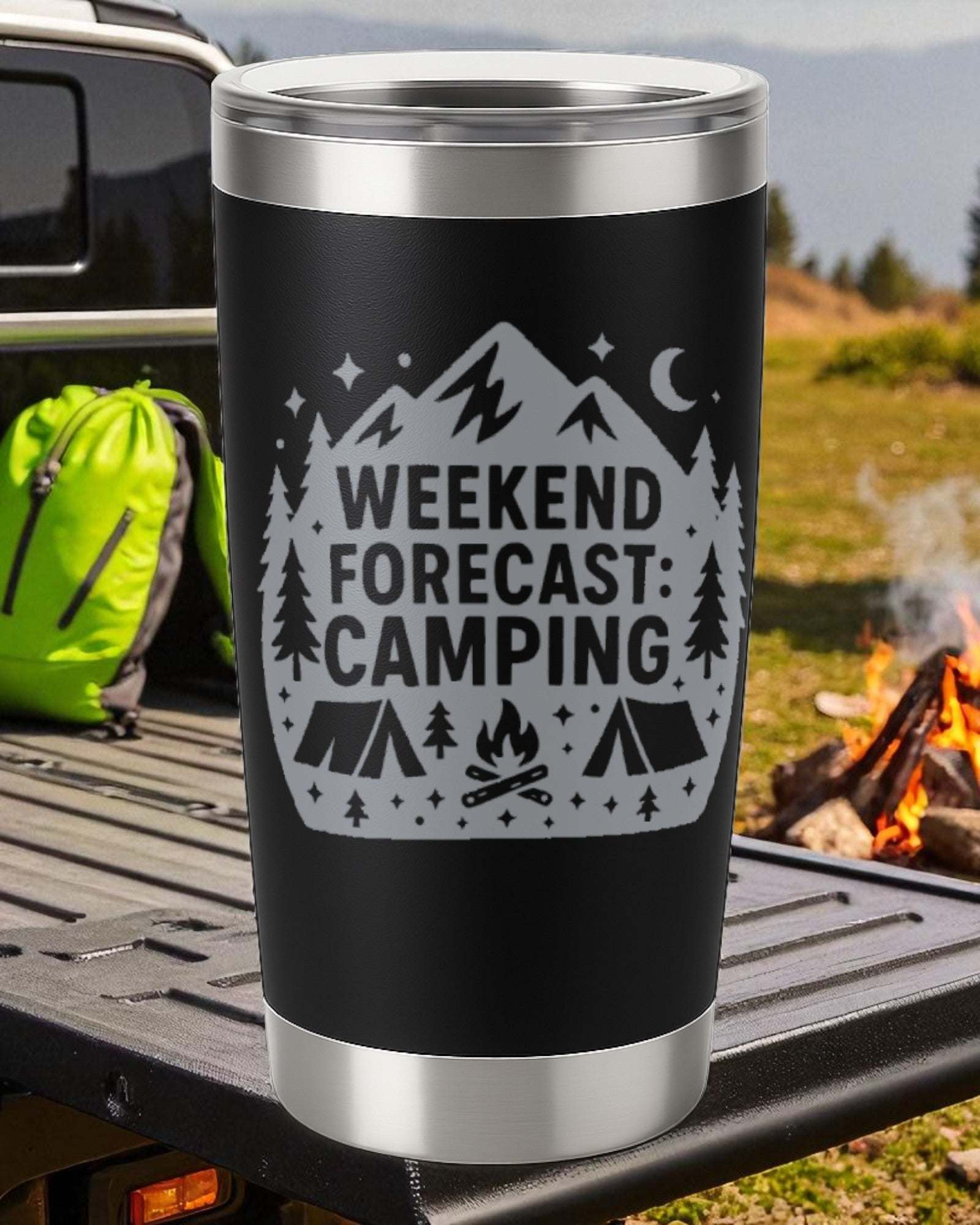 20oz black stainless steel tumbler engraved with "Weekend Forecast: Camping" design, with clear slide lid, shown on truck bed near campfire and green backpack