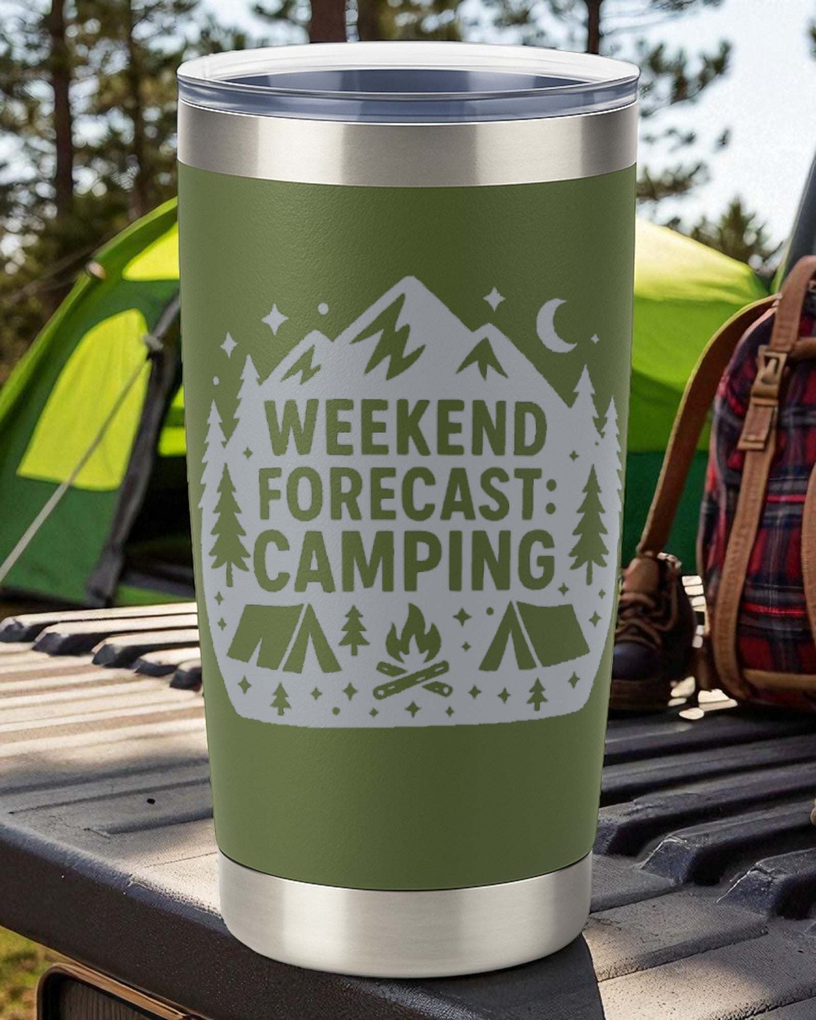 Green 20oz stainless steel tumbler engraved with "Weekend Forecast: Camping" design, clear slide lid, outdoors setting.