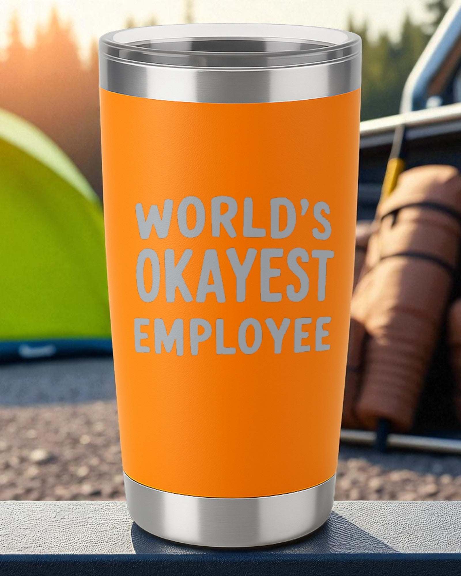 Orange 20oz stainless steel tumbler with "World’s Okayest Employee" laser-engraved text and clear sliding lid
