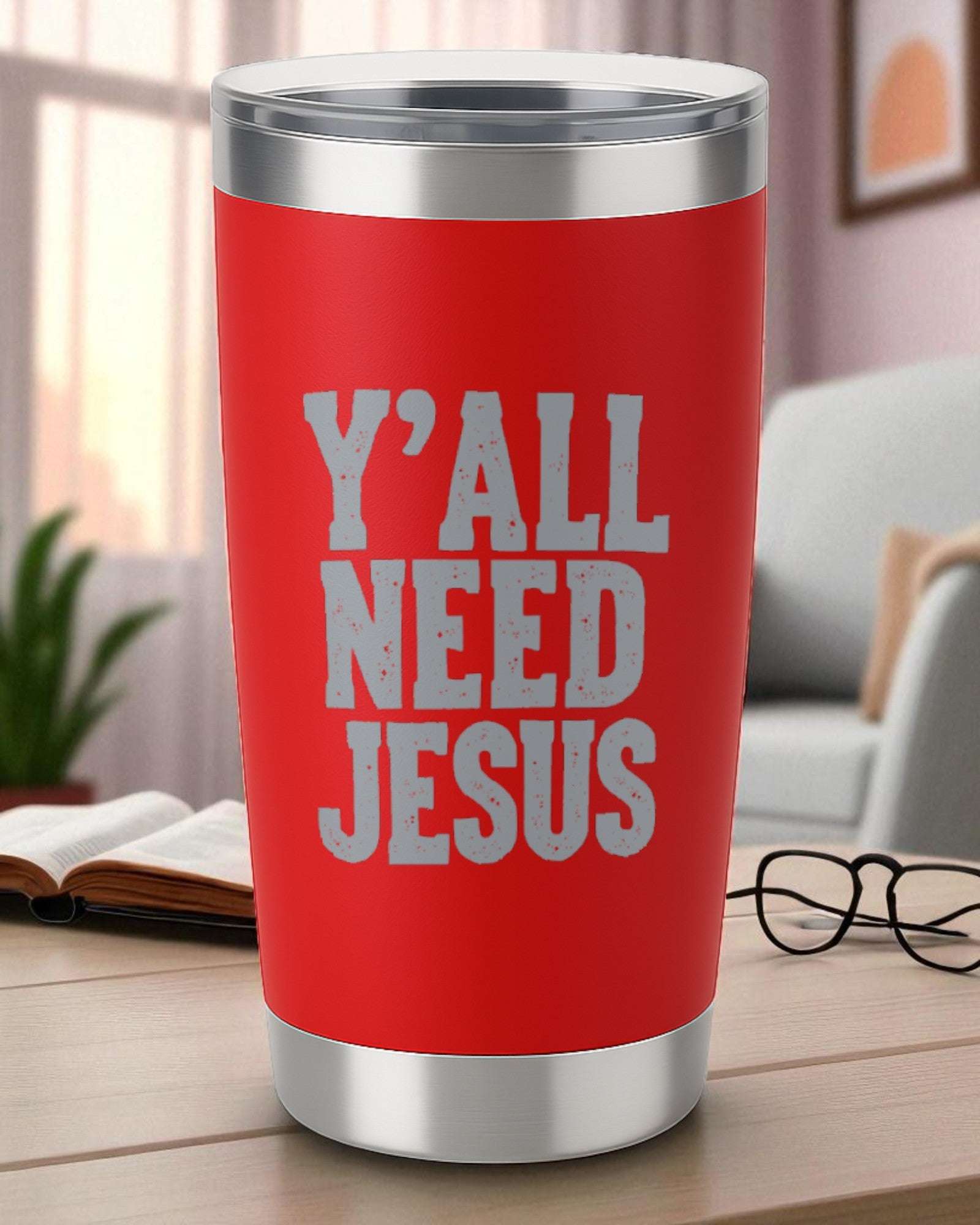 Red 20oz stainless steel tumbler with engraved "Y'all Need Jesus" text and clear lid on a wooden table.